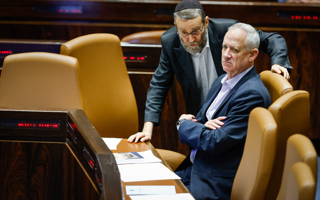 Minister of Defense Benny Gantz speaks with UInited Torah Judaism's MK Moshe Gafni in the Knesset on June 1, 2022. (Olivier Fitoussi/Flash90)
