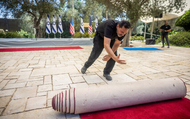 A worker at the President's Residence prepares for the upcoming visit of US President Joe Biden on July 11, 2022. (Yonatan Sindel/Flash90)