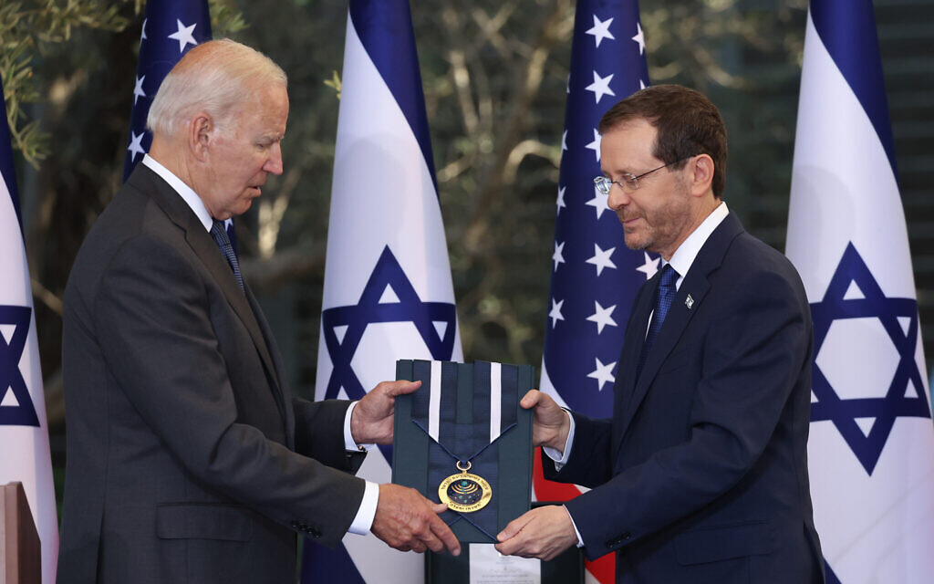 President Isaac Herzog presents the Israeli Presidential Medal of Honor to US President Joe Biden at the President's Residence in Jerusalem, on July 14, 2022. (Yonatan Sindel/Flash90)