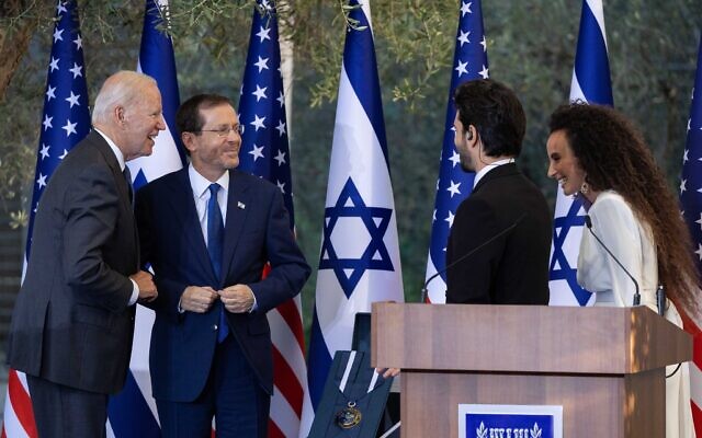 Left to right, US president Joe Biden, President Isaac Herzog, singers Ran Dankner and Yuval Dayan during a ceremony at the President's Residence in Jerusalem, on July 14, 2022. (Yonatan Sindel/Flash90)