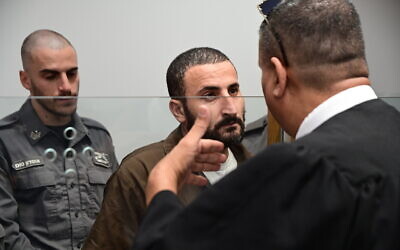 Ahmad Rashdan is brought for a court hearing in Tel Aviv District Court on July 31, 2022.  (Avshalom Sassoni/Flash90)