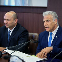 Prime Minister Yair Lapid (right) and alternate prime minister Naftali Bennett at a cabinet meeting at the Prime Minister's Office in Jerusalem on July 31, 2022. (Marc Israel Sellem/Pool)
