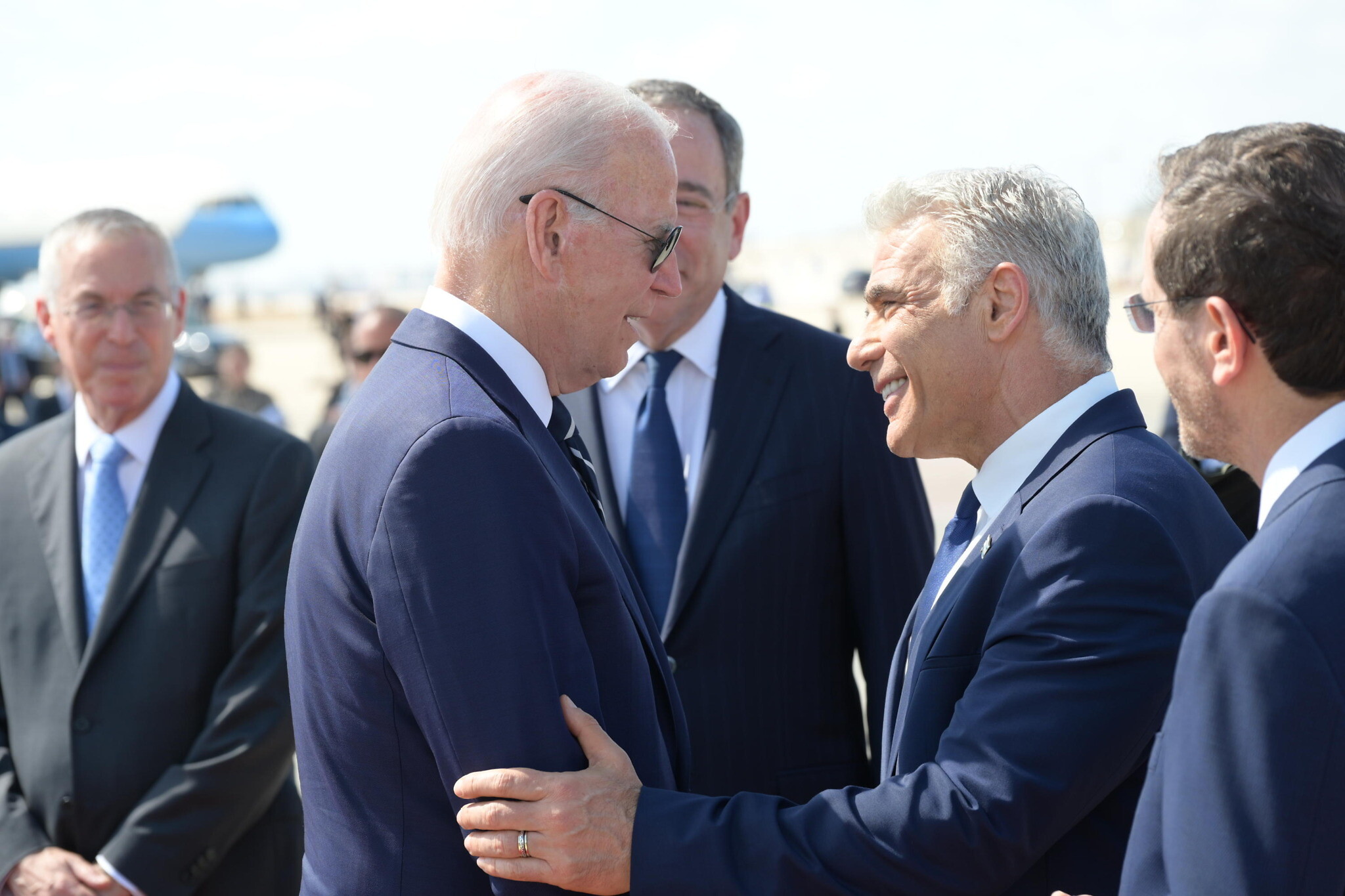 US President Joe Biden takes his leave of Prime Minister Yair Lapid before departing Israel’s Ben Gurion Airport on July 15, 2022 for Jeddah, Saudi Arabia. (Amos Ben Gershom / GPO)