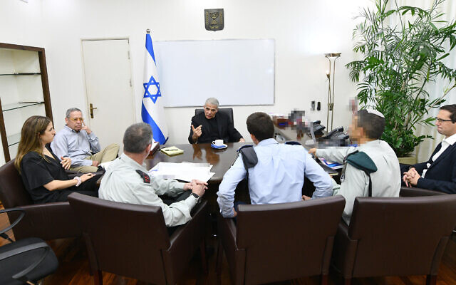 New Prime Minister Yair Lapid holds a meeting with security chiefs at the Kirya military headquarters in Tel Aviv, July 1, 2022. (Haim Zach/GPO)