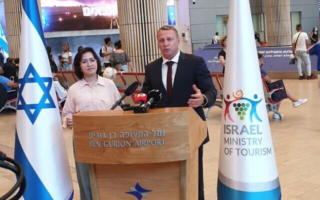 Tourism Minister Yoel Razvozov (right) with Belinda Desoyo Lee Marcelo, the one millionth tourist to visit Israel in 2022, on July 10, 2022 at Ben Gurion Airport. (Tourism Ministry)