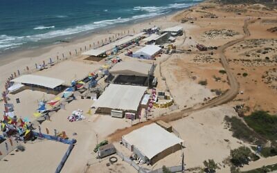 Aerial view of the Maccabiah compound on Poleg beach, Netanya, July 11, 2022. The access road cut through the dune can be seen on the right. (|Rika Edelman)
