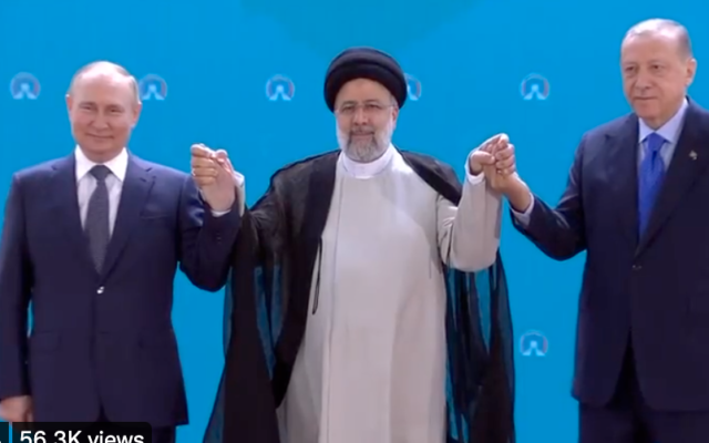 Russian President Vladimir Putin, Iran President Ebrahim Raisi and Turkish President Recep Tayyip Erdogan hold hands during a trilateral summit in Tehran on July 19, 2022. (Screen capture/Twitter)
