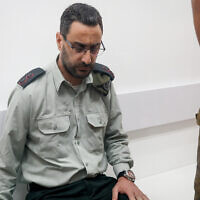Lt. Col. Dan Sharoni, an IDF officer accused of sexual offenses, arrives for a court hearing at a military court in Beit Lid, July 24, 2022. (Flash90)