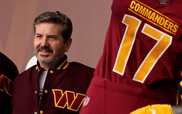 Dan Snyder, co-owner and co-CEO of the Washington Commanders, poses for photos during an event to unveil the NFL football team's new identity, February 2, 2022, in Landover, Maryland. (AP Photo/Patrick Semansky)