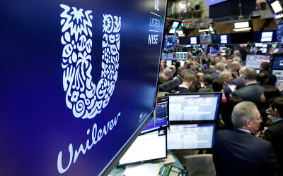 The Unilever logo above a trading post on the floor of the New York Stock Exchange, March 15, 2018. (AP Photo/Richard Drew, File)