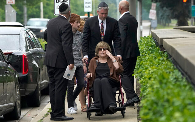 Linda Straus, widow of Stephen Straus, who was killed in a mass shooting at the Fourth of July parade in Highland Park, Ill., arrives for a funeral service with family members at the Jewish Reconstructionist Congregation, July 8, 2022, in Evanston, Ill. Straus was buried earlier in a private family service. (AP Photo/Charles Rex Arbogast)