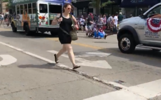 People seen fleeing as shots are heard during a July 4 parade held at Highland Park in Chicago on July 4, 2022. (Screenshot/Twitter)