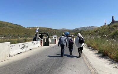 Yeshiva students at a checkpoint blocking the road to the illegal outpost of Homesh in northern West Bank, May 26, 2022. (Carrie Keller-Lynn/The Times of Israel)