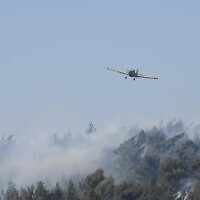 A firefighting plane is seen over a fire near the towns of Manara and Yiftah in northern Israel, July 2, 2022. (Israel Defense Forces via Israel Fire and Rescue Services)