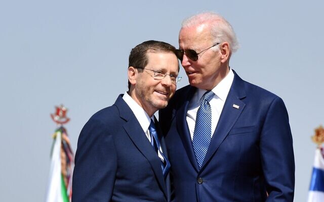 US President Joe Biden (right) greets President Isaac Herzog at Ben Gurion Airport on July 13, 2022. (Haim Zach/GPO)