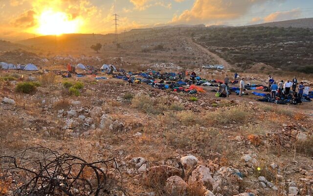 The new illegal settlement outpost of 'Givat Netanel' just north of Kiryat Arba on Thursday morning, July 21, 2022. Several hundred settler activists were still present at the site following a massive campaign to create new outposts by the Nachala settlement organization on Wednesday. (Courtesy Nachala Settlement Movement)