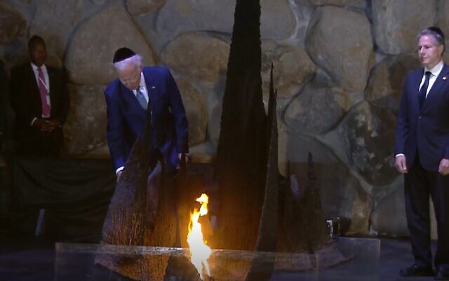 US President Joe Biden rekindles the eternal flame at the Yad Vashem Holocaust museum in Jerusalem, July 13, 2022. (Screenshot)