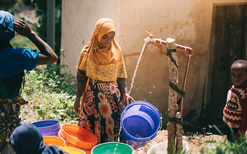 Malindi, Tanzania villagers experience clean running water for first time after Afrikan helps them connect to a clean water source. (Idan Arad/Courtesy of Afrikan)