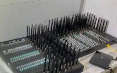 The machines used to send millions of text messages a day offering drugs in a Channel 12 news report broadcast on July 22, 2022. (Screengrab/Israel Police via Channel 12)
