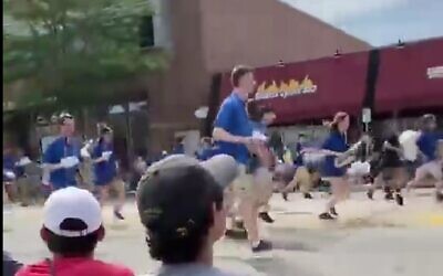 Parade participants seen fleeing as shots are heard during in Highland Park, Illinois on July 4, 2022. (Screenshot/Twitter)