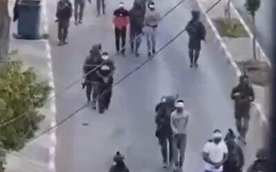 Screengrab said to show Israeli troops escorting detained Palestinians in Silwad, West Bank on July 6, 2022 (Screen grab/Twitter)