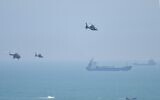 Chinese military helicopters fly past Pingtan island, one of mainland China's closest point from Taiwan, in Fujian province on August 4, 2022. (Hector RETAMAL / AFP)