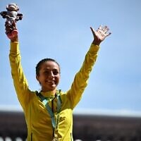 Australian gold medalist Jemima Montag celebrates on the podium during the medal ceremony for the women's 10,000m athletics event at the Alexander Stadium, in Birmingham on day nine of the Commonwealth Games in Birmingham, central England, August 6, 2022. (Ben Stansall/AFP)
