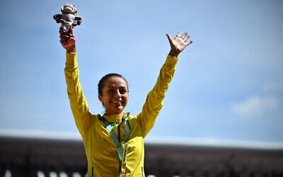 Australian gold medalist Jemima Montag celebrates on the podium during the medal ceremony for the women's 10,000m athletics event at the Alexander Stadium, in Birmingham on day nine of the Commonwealth Games in Birmingham, central England, August 6, 2022. (Ben Stansall/AFP)