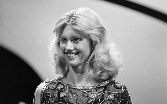 In this file photo taken on November 25, 1978 Australian actress and singer Olivia Newton-John records a TV show at the Studio des Buttes Chaumont in Paris. (GEORGES BENDRIHEM / AFP)