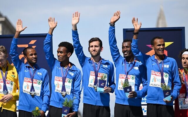 From left to right: Gold medalists, Israel's Maru Teferi, Israel's Gashau Ayale, Israel's Omer Ramon , Israel's Yimer Getahun, and Israel's Girmaw Amare celebrate on the podium after the men's marathon during the European Athletics Championships in Munich, southern Germany on August 15, 2022. (Ina Fassbender/AFP)