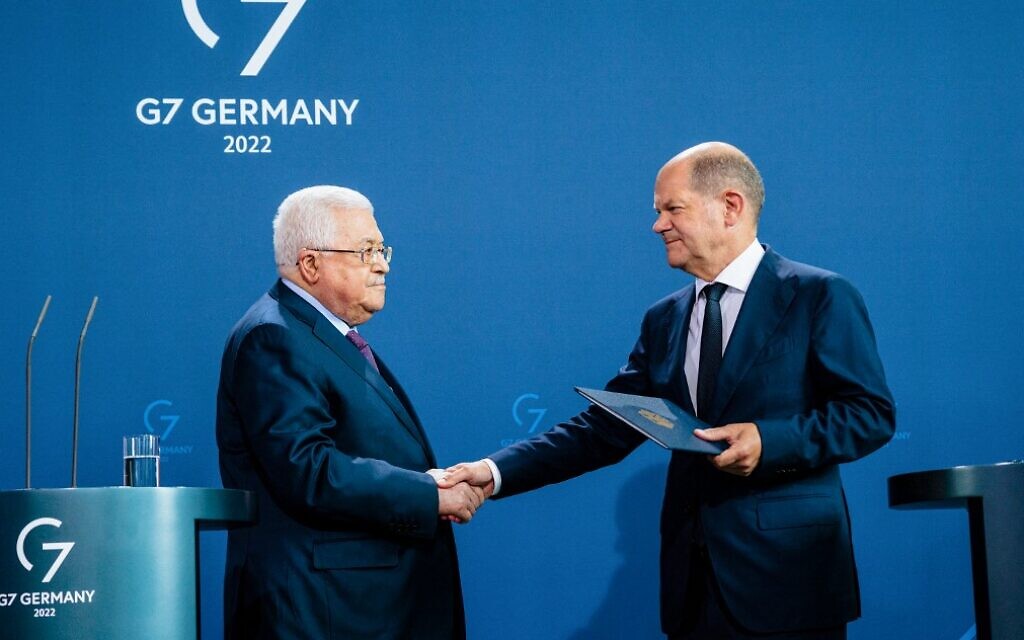 German Chancellor Olaf Scholz and Palestinian Authority President Mahmoud Abbas shake hands after a press conference at the Chancellery in Berlin, Germany, on August 16, 2022. (Jens Schlueter/AFP)