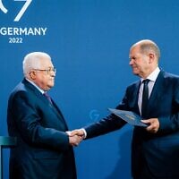 German Chancellor Olaf Scholz and Palestinian Authority President Mahmoud Abbas shake hands after a press conference at the Chancellery in Berlin, Germany, on August 16, 2022. (Jens Schlueter/AFP)
