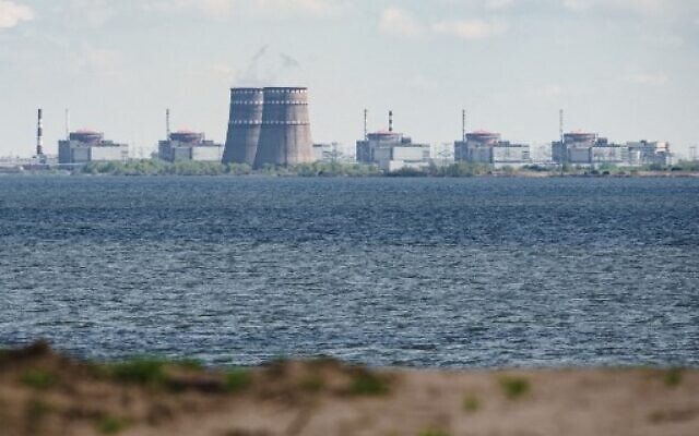 The Zaporizhzhia nuclear power plant, in the distance, situated in the Russian-controlled area of Enerhodar, seen from Nikopol, on April 27, 2022. (Ed JONES / AFP)