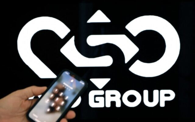 In this file photo a photographic illustration shows a mobile phone near the NSO Group company logo in the Israeli city of Netanya on February 9, 2022. (JACK GUEZ / AFP)