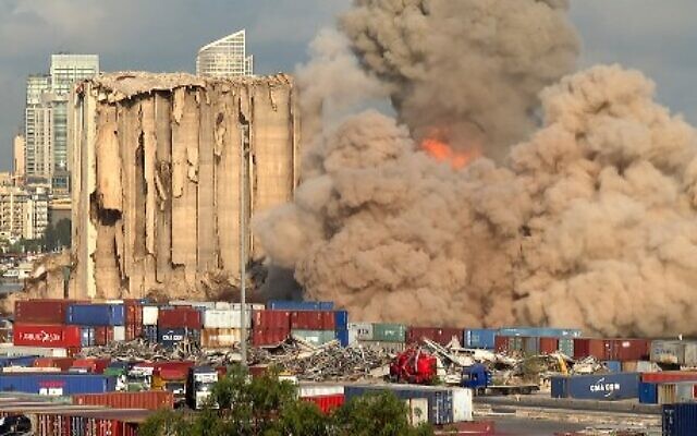 This grab from AFPTV footage shows a smoke plume rising after the new collapse of the northern section of the grain silos at the port of Lebanon's capital Beirut, August 23, 2022. (Dylan COLLINS/AFPTV/AFP)