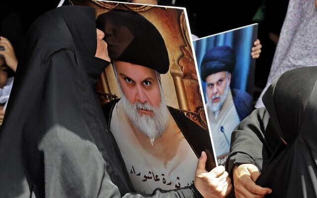 A woman supporter of Iraqi Shiite cleric Muqtada al-Sadr kisses his portrait at the vigil outside parliament headquarters in the capital Baghdad's high-security Green Zone on August 26, 2022, during a protest against the nomination of a rival Shiite faction for government leadership. (Ahmad al-Rubaye/AFP) A woman supporter of Iraqi Shiite cleric Muqtada al-Sadr kisses his portrait at the vigil outside parliament headquarters in the capital Baghdad's high-security Green Zone on August 26, 2022, during a protest against the nomination of a rival Shiite faction for government leadership. (Ahmad al-Rubaye/AFP)