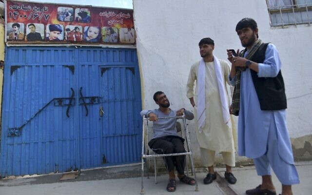 Nasratullah Malikzada (R), the nephew of Aimal Ahmadi, stands outside the house where a US drone strike was carried out in Kabul, August 27, 2022. (Ahmad SAHEL ARMAN / AFP)
