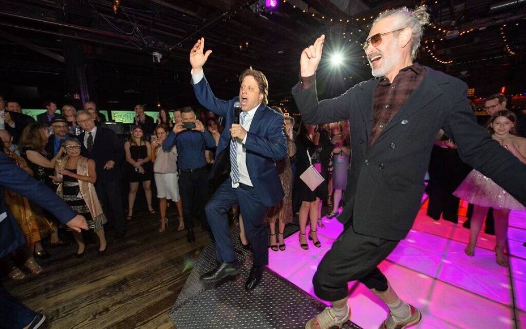Peter Shapiro, left, does the hora with musician Matisyahu at the Brooklyn Bowl in this undated photo. (Courtesy/ Marc Millman)