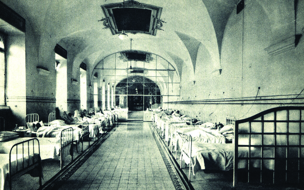 Patients lie in beds in the 'Syndrome K' unit at Fatebenefratelli Hospital. (Syndrome K' Freestyle Digital Media/ via JTA)