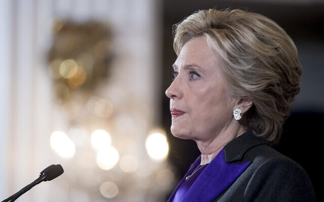 FILE - In this Nov. 9, 2016, file photo, Hillary Clinton pauses while delivering a speech conceding her defeat to Republican Donald Trump after the hard-fought presidential election. The AP reported on Nov.
 10, 2017, that an article claiming Clinton didn't give a concession speech was false. (AP Photo/Andrew Harnik, File)