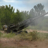 FILE - Ukrainian soldiers fire at Russian positions from a US-supplied M777 howitzer in Ukraine's eastern Donetsk region, June 18, 2022. (AP/Efrem Lukatsky, File)