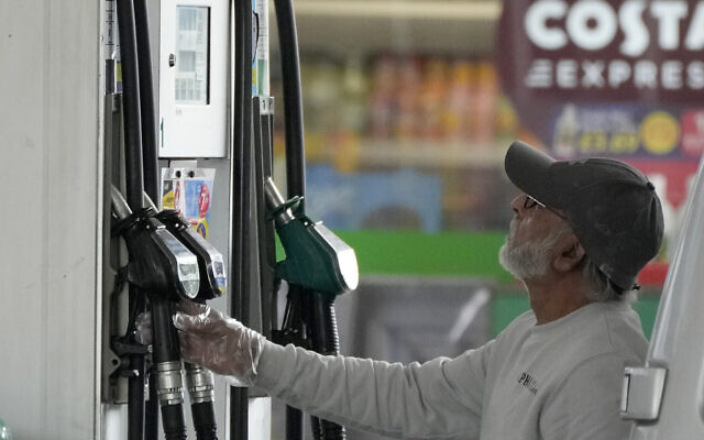 Illustrative: A driver looks at the pump at a gas station in London, June 9, 2022. (AP Photo/Frank Augstein, File)