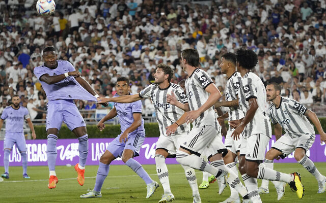 Juventus midfielder Manuel Locatelli pulls on the jersey of Real Madrid defender David Alaba, left, during the second half of a club friendly soccer match July 30, 2022, in Pasadena, California. (AP Photo/Marcio Jose Sanchez)