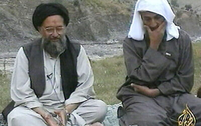 Osama bin Laden, right, listens as his top deputy Ayman al-Zawahiri speaks in this image made from undated video tape broadcast by Al-Jazeera on April 15, 2002. (AP Photo/Al-Jazeera/APTN)