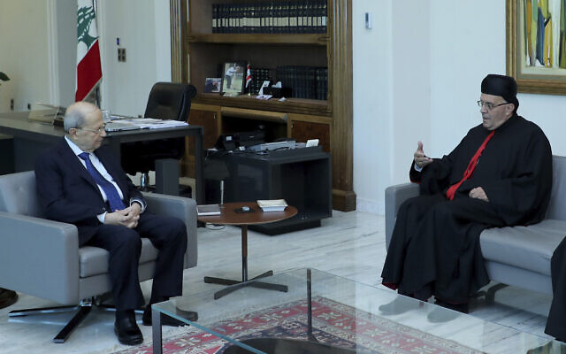Lebanese president Michel Aoun, left, meets with Lebanese Maronite archbishop Moussa el-Hajj, at the presidential palace, in Baabda east of Beirut, Lebanon, July 22, 2022.  (Dalati Nohra via AP)