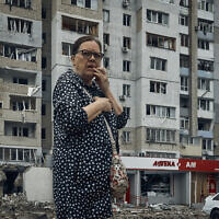 A woman stands in the aftermath of the Russian shelling in Mykolaiv, Ukraine, Aug. 3, 2022 (AP Photo/Kostiantyn Liberov)