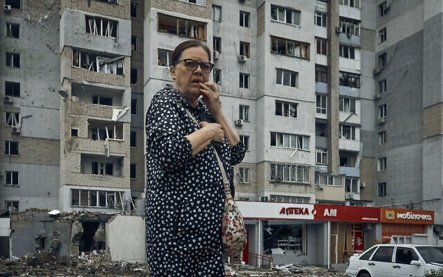 A woman stands in the aftermath of the Russian shelling in Mykolaiv, Ukraine, Aug. 3, 2022 (AP Photo/Kostiantyn Liberov)