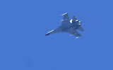 A Chinese fighter jet flies in the direction of Taiwan seen from the 68-nautical-mile scenic spot, the closest point in mainland China to the island of Taiwan, in Pingtan in southeastern China's Fujian Province, Friday, Aug. 5, 2022.  (AP/Ng Han Guan)
