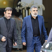 Iranian deputy foreign minister Reza Najafi, left, and Iranian AEOI spokesperson Behrouz Kamalvandi, right, are leaving the Palais Coburg where closed-door nuclear talks take place in Vienna, Austria, August 5, 2022. (AP Photo/Florian Schroetter)