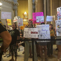 Abortion-rights protesters fill Indiana Statehouse corridors and cheer outside legislative chambers, Friday, August 5, 2022, as lawmakers vote to concur on a near-total abortion ban, in Indianapolis. (AP/Arleigh Rodgers)